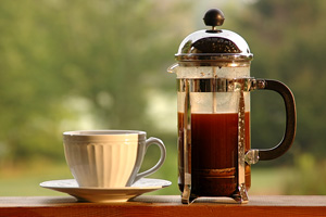 french press and coffee cup